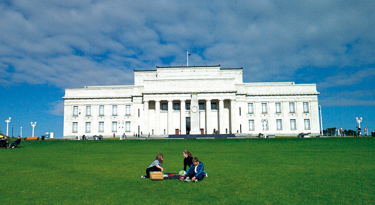 War Memorial museum, a large white building, on an expanse of grass with picnickers.